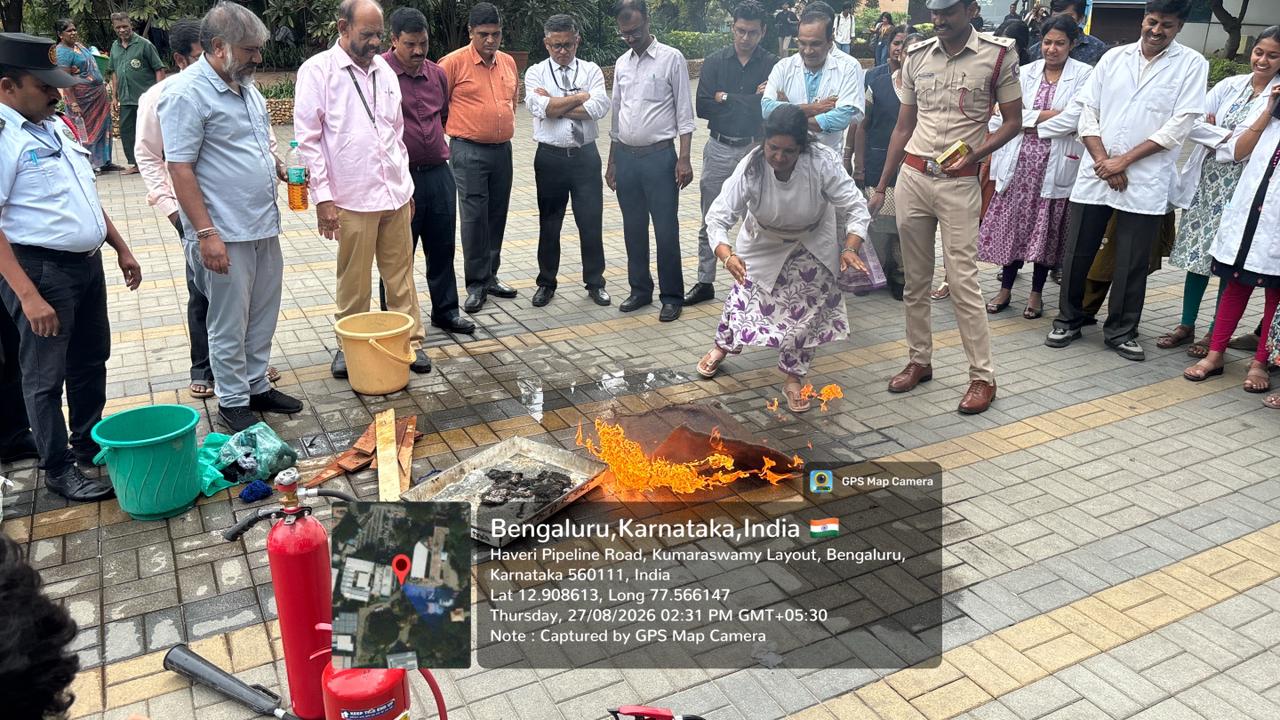Participant demonstrating blanket drill technique to extinguish flame